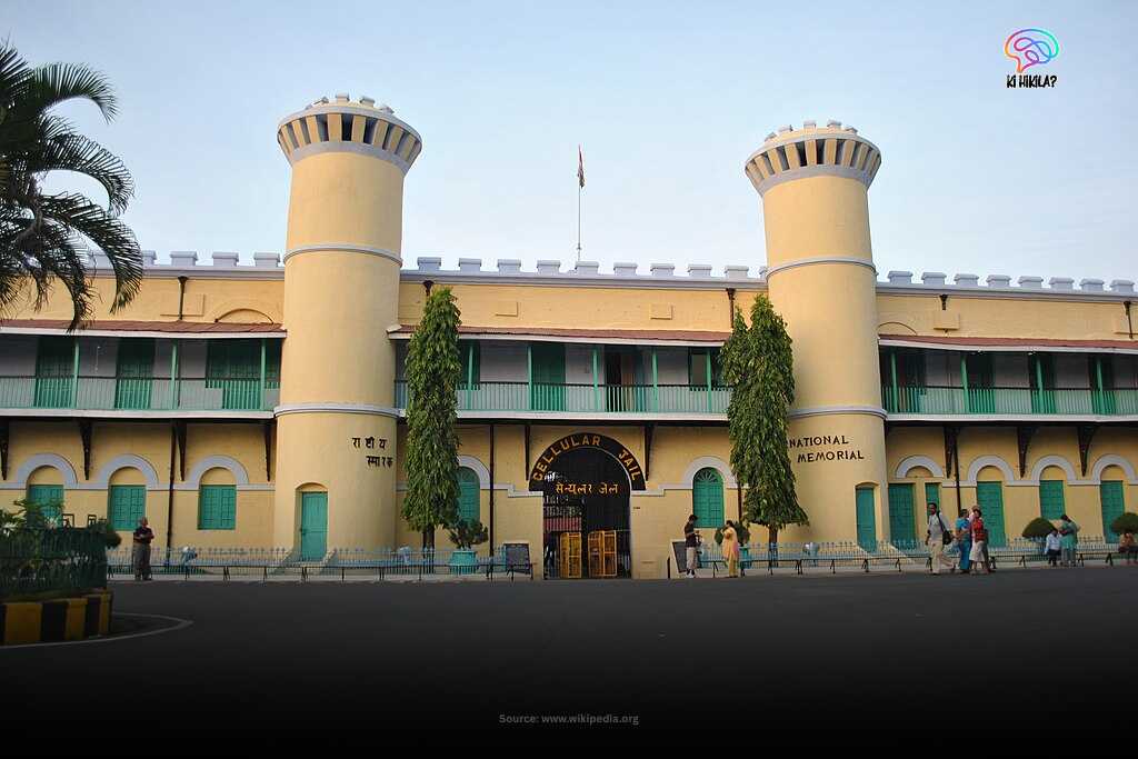 The facade of the historic Cellular Jail, or Kala Pani, National Memorial in Port Blair, with its distinct yellow walls, watchtowers, and the Indian flag.