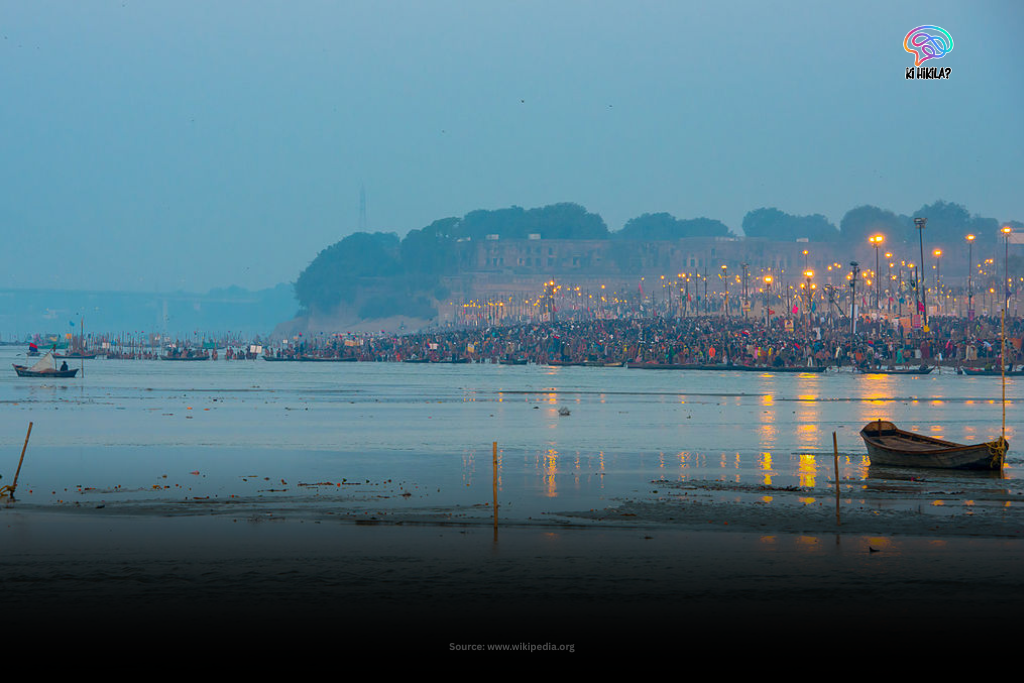 A panoramic view of the Kumbh Mela gathering on the banks of the river at Sangam in Prayagraj, Uttar Pradesh, during dusk.