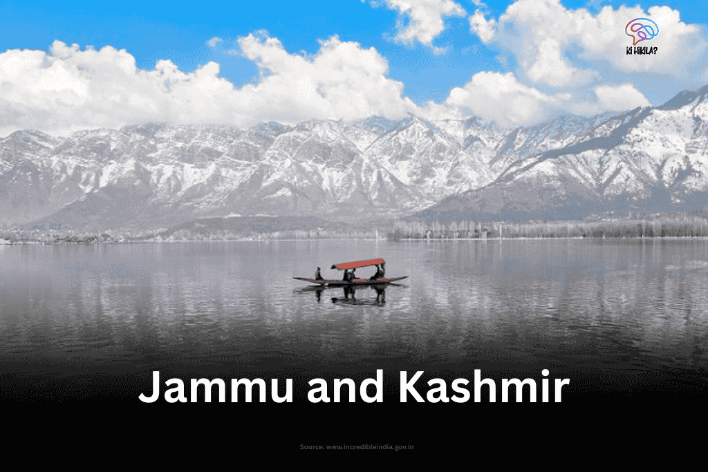 A lone shikara glides on the serene, reflective waters of Dal Lake, framed by majestic, snow-capped mountains in Jammu and Kashmir.