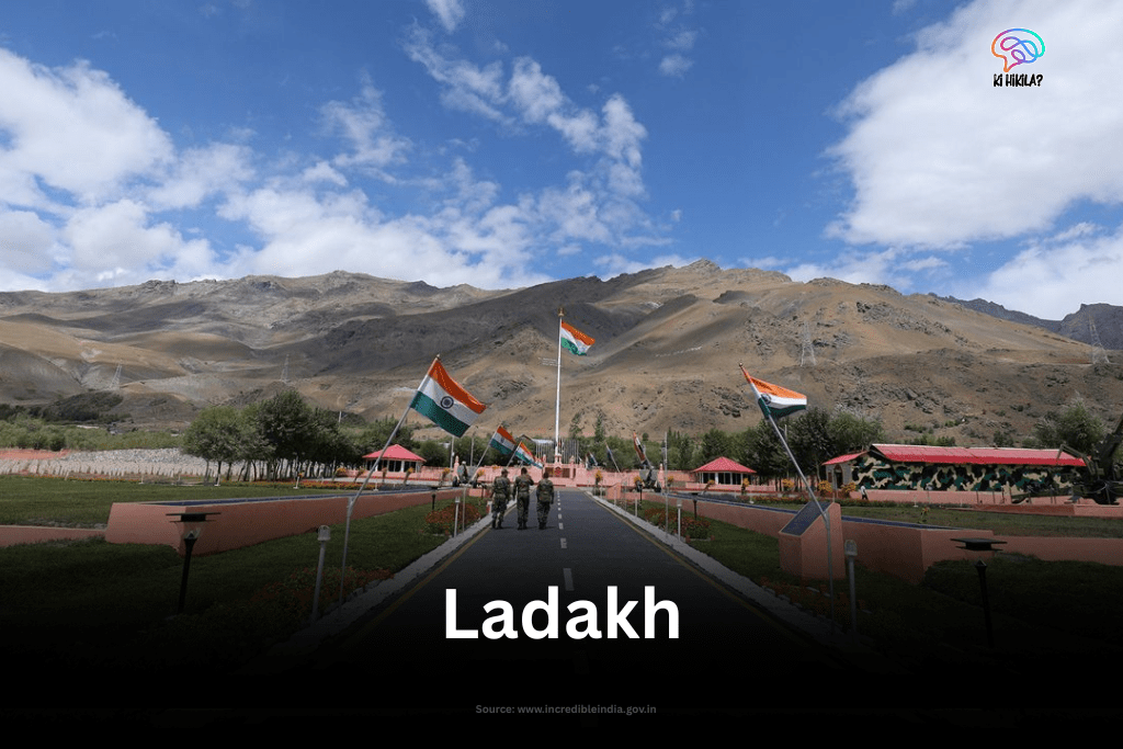 The Kargil War Memorial in Dras, Ladakh, with Indian flags lining the central walkway leading towards the rugged mountain backdrop.