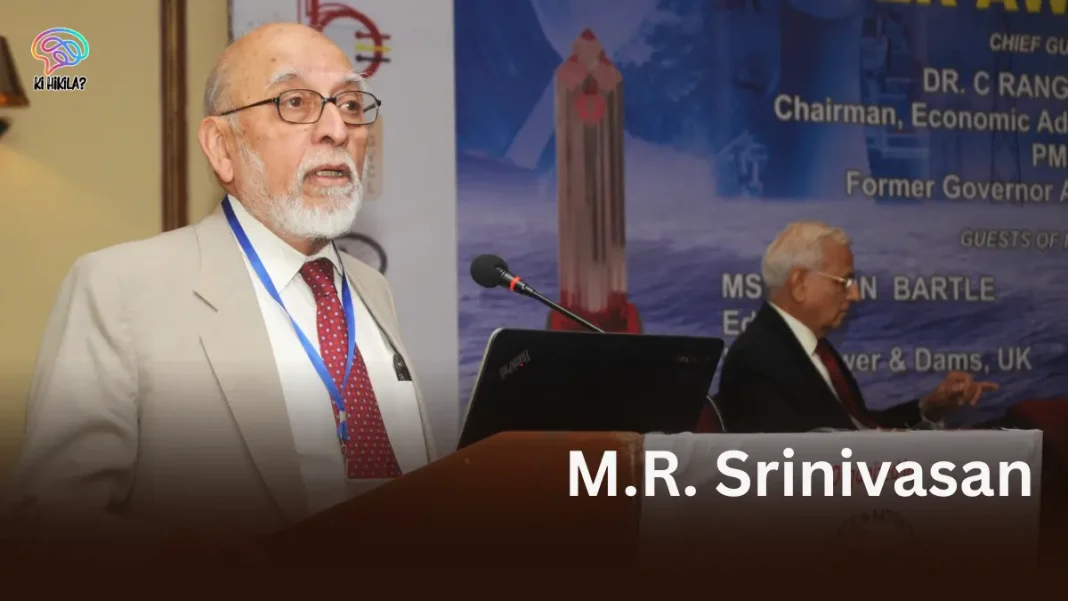 A photo of M.R. Srinivasan, a distinguished scientist, speaking at a podium with a conference banner in the background.